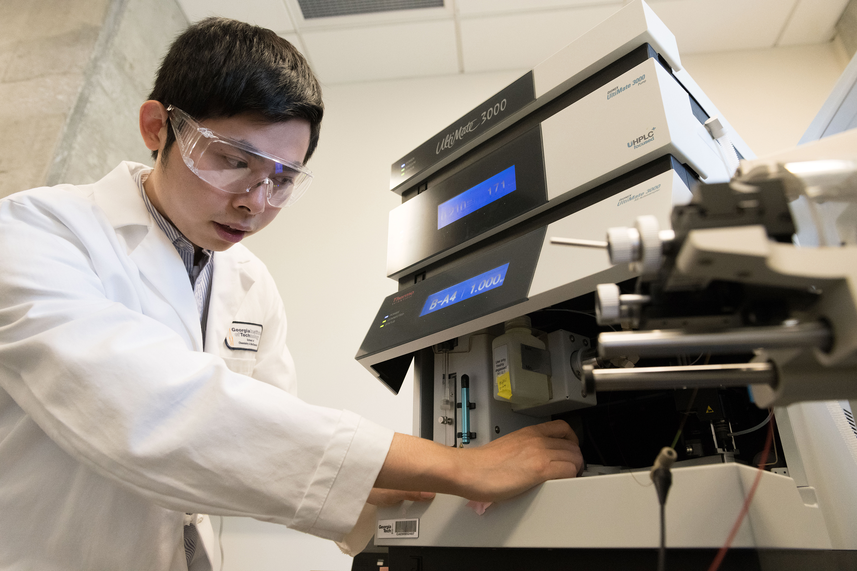 Graduate research assistant Haopeng Xiao loads a glycoprotein sample, which was culled with the "chemical octopus" co-developed in Ronghu Wu's lab at Georgia Tech, into a mass spectrometer. The broad array of captured glycoproteins produce identifiable signals, including those from trace glycoprotein species that previously could not be so comprehensively collected and are vital to early cancer detection. Credit: Georgia Tech / Allison Carter