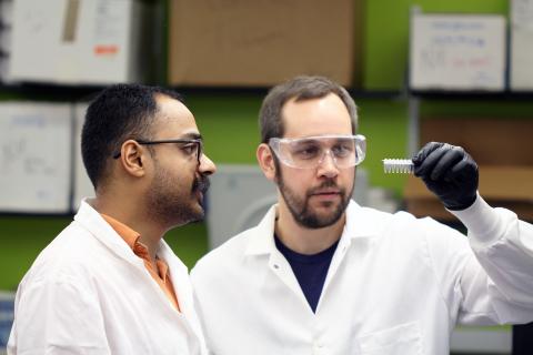 Graduate research assistant Chinar Patil (l.) and postdoctoral researcher Zachary Johnson (r.) sequence DNA for a study that found gene activation coinciding with behavior in fish and looked for clues to the common evolution of genes and behaviors. Patil and Johnson are in Todd Streelman's Georgia Tech lab. Credit: Georgia Tech / Ben Brumfield