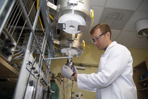 Graduate research assistant Ben deGlee hooks up electrodes to a testing unit used to test the new fuel cell in Meilin Liu's lab at Georgia Tech. Credit: Georgia Tech / Christopher Moore