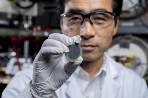 Principal investigator Meilin Liu holds up an example of the new, practical, affordable fuel cell in his lab at the Georgia Institute of Technology. Credit: Georgia Tech / Christopher Moore