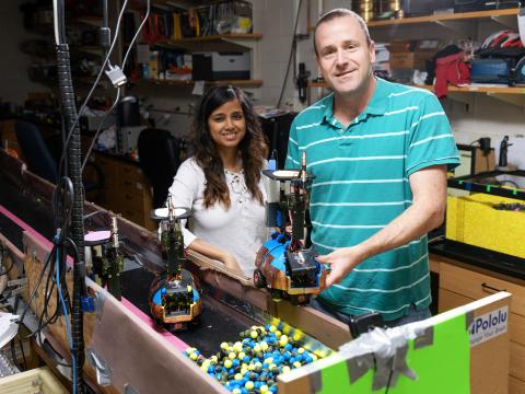Georgia Tech Graduate Research Assistant Bahnisikha Dutta and Professor Daniel Goldman are shown with autonomous robots built to understand the challenges of moving in confined spaces such as tunnels. (Credit: Rob Felt, Georgia Tech)