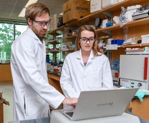 Research Scientist Dan Cornforth and Postdoctoral Fellow Carolyn Ibberson are shown in the laboratory of Professor Marvin Whiteley at Georgia Tech. They are part of a research team studying differences in how bacteria behave in laboratory conditions compared to in human infections. (Credit: Rob Felt, Georgia Tech)