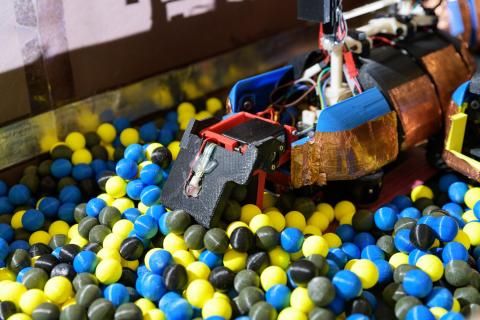 Image shows a robot built in the laboratory of Professor Daniel Goldman at Georgia Tech designed to dig 3D printed spheres that are intended to simulate the moist soil in which ants dig. (Credit: Rob Felt, Georgia Tech)