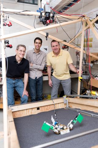 Researchers (l-r) Richard Blob, Ben McInroe and Dan Goldman examine a robot named MuddyBot whose locomotion was inspired by the mudskipper. The robot has two limbs and a powerful tail to move though a trackway that can be raised to simulate granular slopes. Blob is a professor at Clemson University; McInroe was a student at Georgia Tech when the research was conducted, and Goldman is a professor at Georgia Tech (Credit: Rob Felt, Georgia Tech)